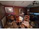 View of living room with a ceiling fan, desk and furniture, with red walls at 7631 Briarwood Dr, Port Richey, FL 34668