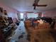 Spacious living room featuring floral furniture, and lots of items on the floor at 7631 Briarwood Dr, Port Richey, FL 34668