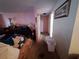 View of pink living room leading to hallway, with pink walls and items scattered around at 7631 Briarwood Dr, Port Richey, FL 34668