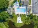 Aerial view of the community pool, cabana, and surrounding green space with water features at 8158 Sturbridge Ct # D, Weeki Wachee, FL 34613