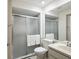 Bathroom with a glass-enclosed shower, toilet, and vanity with sink and mirror at 8158 Sturbridge Ct # D, Weeki Wachee, FL 34613