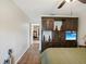Spacious bedroom with wood floors and a decorative cabinet and shelving unit at 8158 Sturbridge Ct # D, Weeki Wachee, FL 34613
