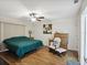 Well-lit bedroom featuring wood-look floors, ceiling fan, and comfortable sitting area at 8158 Sturbridge Ct # D, Weeki Wachee, FL 34613