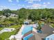 Aerial view of the community pool with lots of tables, umbrellas, and lounge chairs at 8158 Sturbridge Ct # D, Weeki Wachee, FL 34613