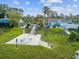 This image showcases a community pool with lounge chairs, tables, and stairs leading down to the pool deck at 8158 Sturbridge Ct # D, Weeki Wachee, FL 34613