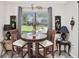 Cozy dining area features a round table, comfortable seating, natural light, and stylish decor at 8158 Sturbridge Ct # D, Weeki Wachee, FL 34613