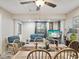 Comfortable dining room with ceiling fan, tile floors, seating and a view of the living area at 8158 Sturbridge Ct # D, Weeki Wachee, FL 34613