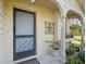 Home entry showcasing decorative front door, potted plants, and charming architectural details at 8158 Sturbridge Ct # D, Weeki Wachee, FL 34613