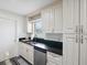 Modern kitchen featuring granite countertops, stainless steel appliances, and white cabinets at 8158 Sturbridge Ct # D, Weeki Wachee, FL 34613