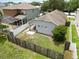Aerial view of the backyard, fenced yard, with patio and neighboring homes at 8335 Crescent Moon Dr, New Port Richey, FL 34655