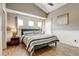 Bright bedroom features a ceiling fan, hardwood flooring, stylish decor and a vaulted ceiling at 8335 Crescent Moon Dr, New Port Richey, FL 34655