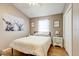 Bedroom with a patterned comforter, matching nightstands, and decorative wall hangings at 8335 Crescent Moon Dr, New Port Richey, FL 34655