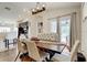 Bright dining room featuring a wooden table, upholstered chairs, and modern lighting fixture at 8335 Crescent Moon Dr, New Port Richey, FL 34655