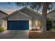 Exterior showcasing a two-car garage and well-kept landscaping at 8335 Crescent Moon Dr, New Port Richey, FL 34655