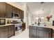 Modern kitchen features dark wood cabinets, stainless steel appliances, and tile flooring at 8335 Crescent Moon Dr, New Port Richey, FL 34655