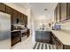 Modern kitchen features dark wood cabinets, stainless steel appliances, and tile flooring at 8335 Crescent Moon Dr, New Port Richey, FL 34655