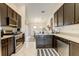 Modern kitchen features dark wood cabinets, stainless steel appliances, and tile flooring at 8335 Crescent Moon Dr, New Port Richey, FL 34655