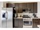 Bright kitchen with stainless steel appliances, dark cabinetry, and ample counter space at 8335 Crescent Moon Dr, New Port Richey, FL 34655