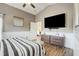 Main bedroom featuring a king-sized bed and a large television at 8335 Crescent Moon Dr, New Port Richey, FL 34655