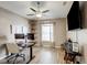 Office space featuring a ceiling fan, corner shelves, a large window, and a wall-mounted TV at 8335 Crescent Moon Dr, New Port Richey, FL 34655