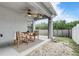 Covered outdoor patio with stylish seating and ceiling fan overlooking the backyard at 8335 Crescent Moon Dr, New Port Richey, FL 34655