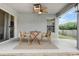 Covered patio with stylish outdoor seating and view of the fenced backyard at 8335 Crescent Moon Dr, New Port Richey, FL 34655