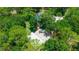 Expansive aerial view showcasing the property's home, pool, lush greenery, and detached garage at 8518 Quail Hollow Blvd, Wesley Chapel, FL 33544