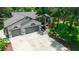 Aerial view of a house featuring a spacious driveway, well-manicured lawn, and a two-car garage at 8518 Quail Hollow Blvd, Wesley Chapel, FL 33544