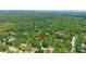 An aerial shot of home nestled among lush trees and forest with a detached garage and privacy at 8518 Quail Hollow Blvd, Wesley Chapel, FL 33544