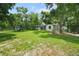 Large backyard featuring play equipment and the rear view of the home at 8518 Quail Hollow Blvd, Wesley Chapel, FL 33544