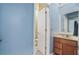 Powder room with blue walls, decorative wallpaper trim, and traditional vanity at 8518 Quail Hollow Blvd, Wesley Chapel, FL 33544