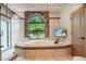 Beautiful bathroom with soaking tub, stone accents, and a glass-enclosed shower at 8518 Quail Hollow Blvd, Wesley Chapel, FL 33544