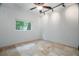 Bedroom with neutral walls, tile flooring, ceiling fan, and track lighting at 8518 Quail Hollow Blvd, Wesley Chapel, FL 33544