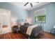 Comfortable bedroom with wood floors, large window, and a full-size bed at 8518 Quail Hollow Blvd, Wesley Chapel, FL 33544