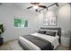 Comfortable bedroom with gray accents, including a padded headboard, blanket, and decorative pillows at 8518 Quail Hollow Blvd, Wesley Chapel, FL 33544