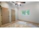 Bedroom with neutral walls, tile flooring, ceiling fan, and window view at 8518 Quail Hollow Blvd, Wesley Chapel, FL 33544