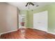 A bedroom with hardwood flooring and an ensuite bath plus breakfast nook access at 8518 Quail Hollow Blvd, Wesley Chapel, FL 33544