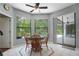 Sunlit breakfast nook with a view of the pool and lanai through sliding glass doors at 8518 Quail Hollow Blvd, Wesley Chapel, FL 33544