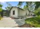 View of the home's rear, showing the screened lanai, walkway, and some landscaping at 8518 Quail Hollow Blvd, Wesley Chapel, FL 33544