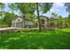 Charming home featuring lush green lawn, rock garden, mature trees and welcoming curb appeal at 8518 Quail Hollow Blvd, Wesley Chapel, FL 33544