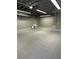 Spacious garage featuring gray tile flooring, sink and shelving at 8518 Quail Hollow Blvd, Wesley Chapel, FL 33544