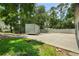 Long, extra wide shot of a garage, a trailer, and the extra space around the building at 8518 Quail Hollow Blvd, Wesley Chapel, FL 33544