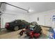 Garage with car and lawnmower parked in front of the garage door at 8518 Quail Hollow Blvd, Wesley Chapel, FL 33544
