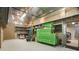 Interior view of a workshop featuring a car, tool chests, and ample storage with shelves at 8518 Quail Hollow Blvd, Wesley Chapel, FL 33544