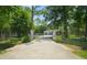 Secure property with a stone-pillar gate and a black iron fence for added privacy and curb appeal at 8518 Quail Hollow Blvd, Wesley Chapel, FL 33544