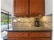 Kitchen features wood cabinets, granite countertops, stainless steel appliances, and view of pool at 8518 Quail Hollow Blvd, Wesley Chapel, FL 33544