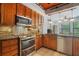 Updated kitchen with granite countertops, stainless steel appliances, and a breakfast bar at 8518 Quail Hollow Blvd, Wesley Chapel, FL 33544