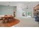 Open-concept living room with stone fireplace and sliding doors to the outdoor living space at 8518 Quail Hollow Blvd, Wesley Chapel, FL 33544