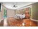 Spacious main bedroom with hardwood floors, stone wall and access to the pool area at 8518 Quail Hollow Blvd, Wesley Chapel, FL 33544