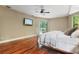Hardwood flooring and neutral paint accentuate this main bedroom with access to the pool area at 8518 Quail Hollow Blvd, Wesley Chapel, FL 33544